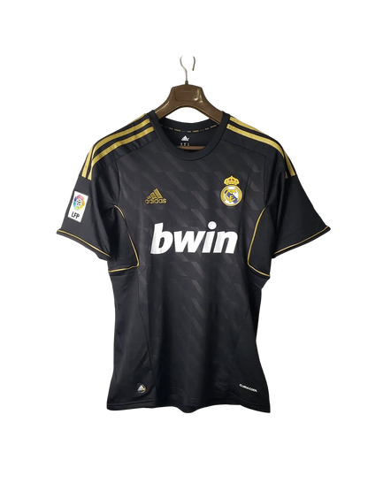 https://cdn.shopify.com/s/files/1/0826/7228/8075/files/20112012-real-madrid-bwin-away-retro-kit-short-sleeve-792373.webp?v=1741197466