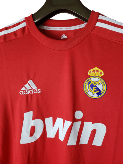 https://cdn.shopify.com/s/files/1/0826/7228/8075/files/20112012-real-madrid-bwin-third-retro-kit-long-sleeve-264843.webp?v=1741197465