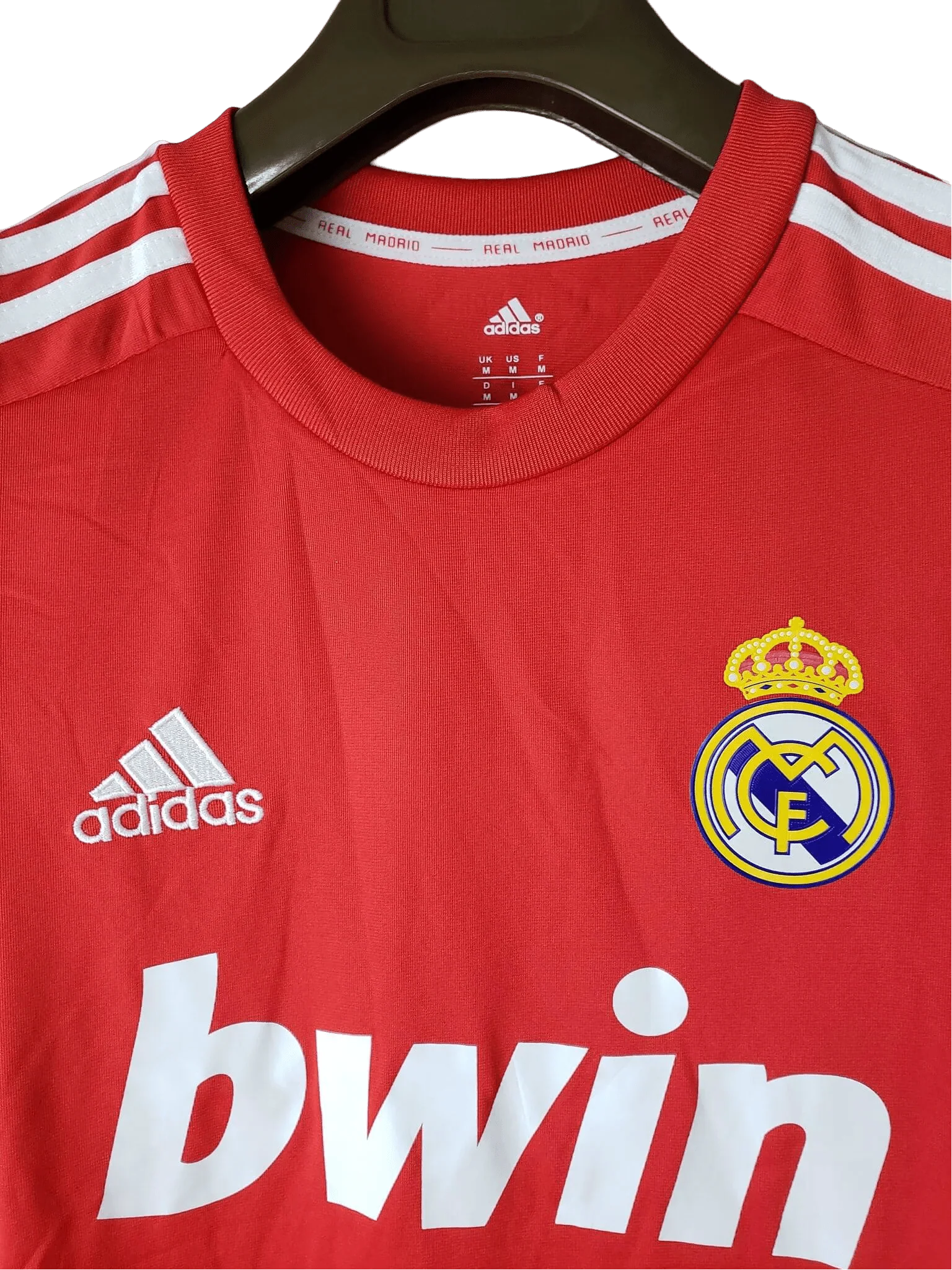 https://cdn.shopify.com/s/files/1/0826/7228/8075/files/20112012-real-madrid-bwin-third-retro-kit-short-sleeve-435079.webp?v=1741197442