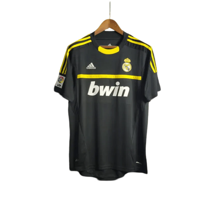https://cdn.shopify.com/s/files/1/0826/7228/8075/files/20112012-real-madrid-bwin-vintage-goalkeeper-black-retro-kit-344144.webp?v=1741197273