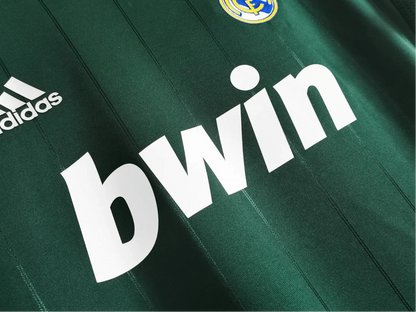 https://cdn.shopify.com/s/files/1/0826/7228/8075/files/20122013-real-madrid-bwin-3rd-green-retro-kit-192134.webp?v=1741197481
