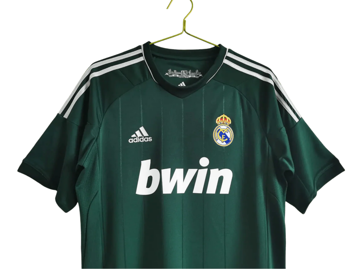 https://cdn.shopify.com/s/files/1/0826/7228/8075/files/20122013-real-madrid-bwin-3rd-green-retro-kit-312916.webp?v=1741197484