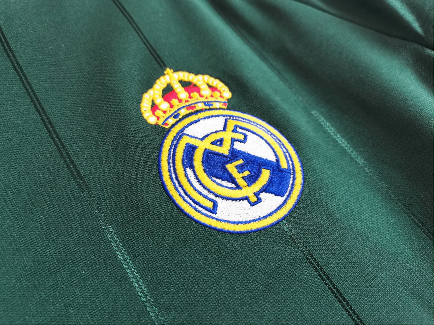 https://cdn.shopify.com/s/files/1/0826/7228/8075/files/20122013-real-madrid-bwin-3rd-green-retro-kit-335888.webp?v=1741197537