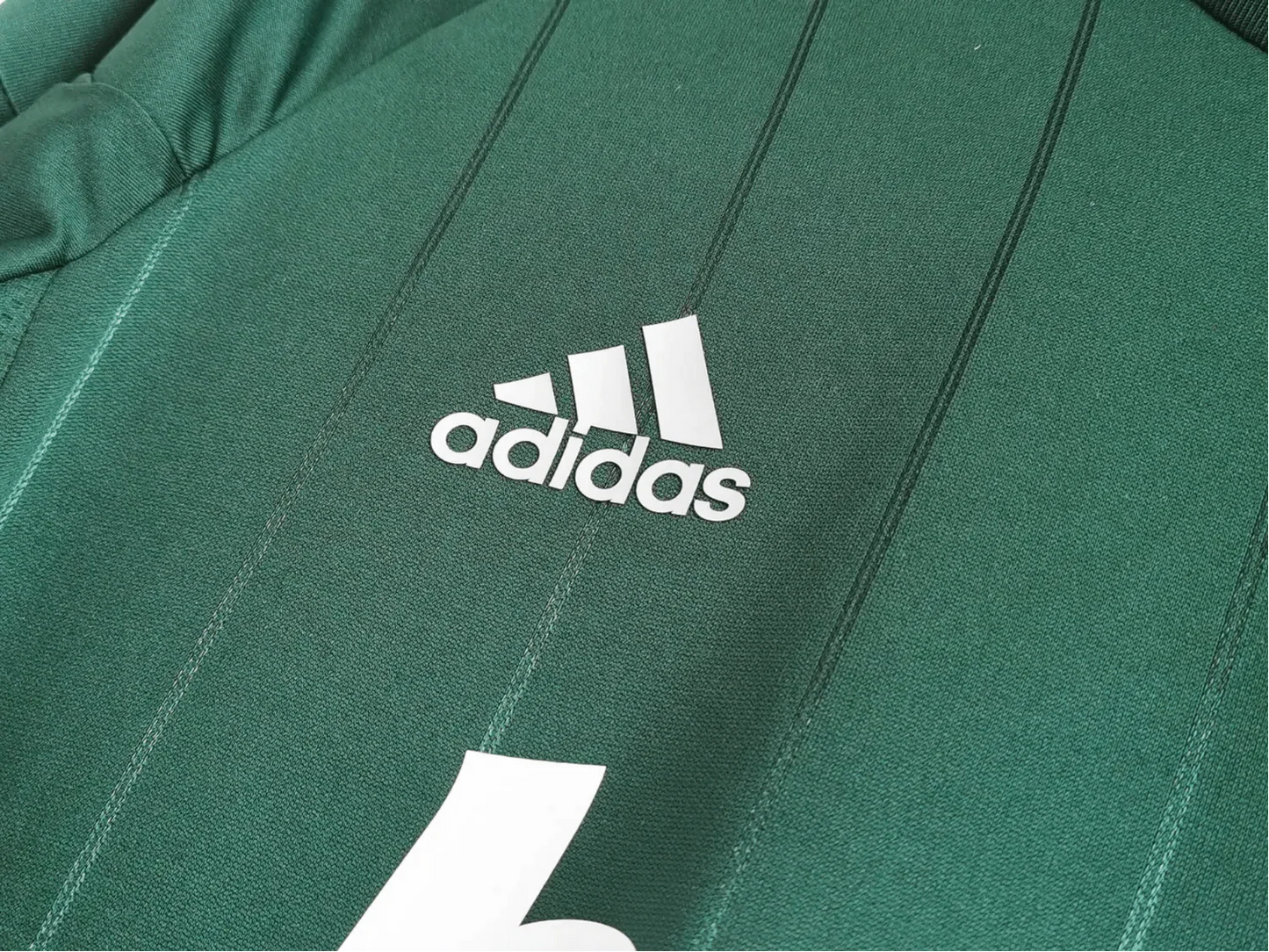 https://cdn.shopify.com/s/files/1/0826/7228/8075/files/20122013-real-madrid-bwin-3rd-green-retro-kit-686554.webp?v=1741197482