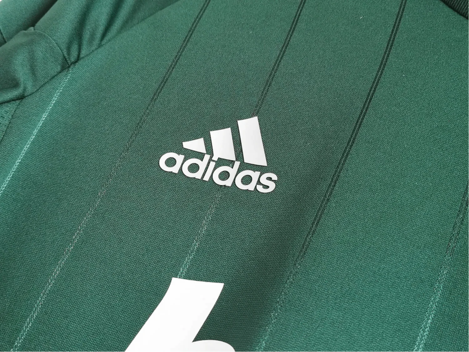 https://cdn.shopify.com/s/files/1/0826/7228/8075/files/20122013-real-madrid-bwin-3rd-green-retro-kit-686554.webp?v=1741197482