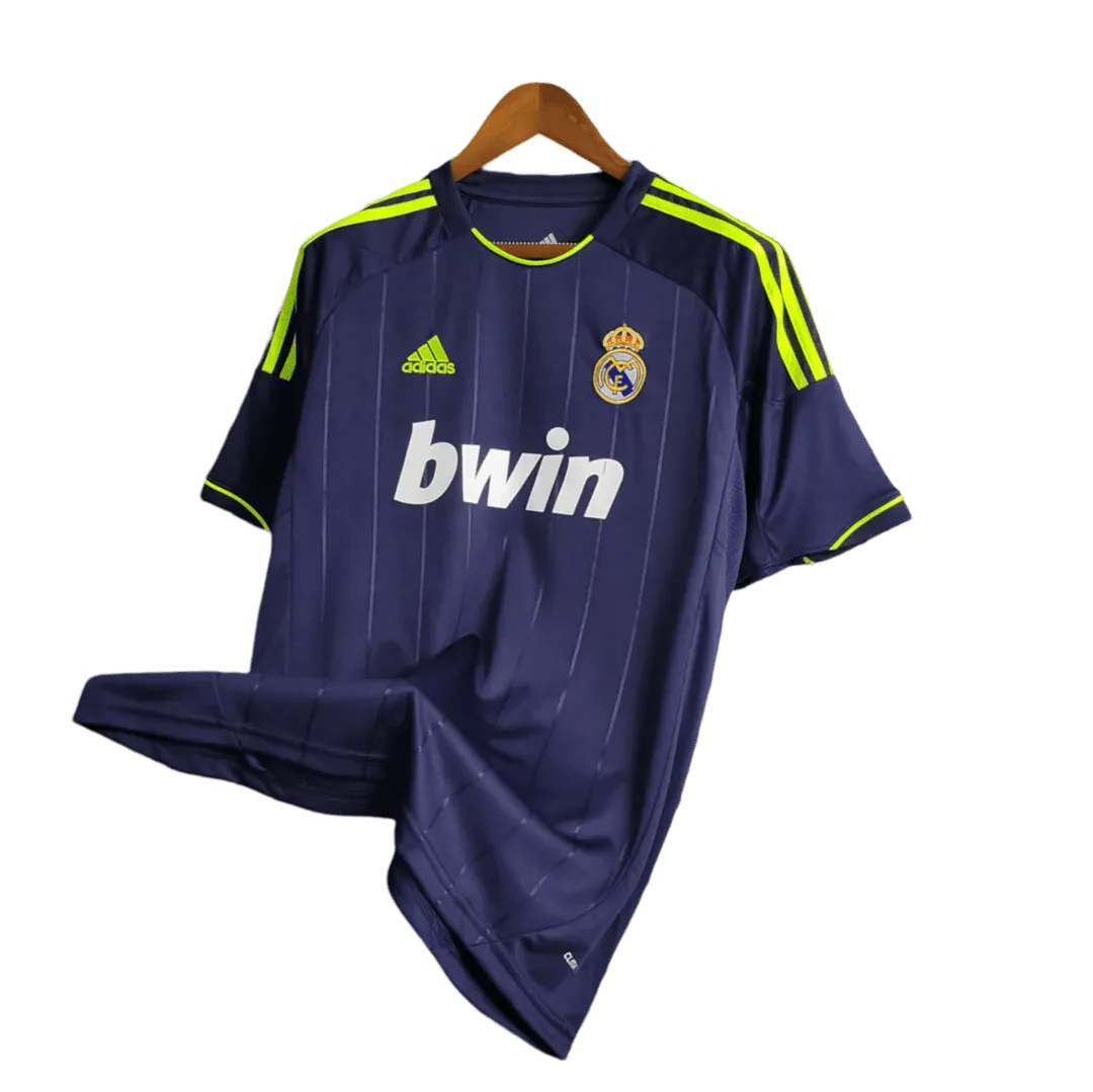 https://cdn.shopify.com/s/files/1/0826/7228/8075/files/20122013-real-madrid-bwin-away-retro-kit-107137.webp?v=1741197473