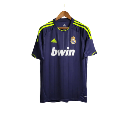 https://cdn.shopify.com/s/files/1/0826/7228/8075/files/20122013-real-madrid-bwin-away-retro-kit-203331.webp?v=1741197474