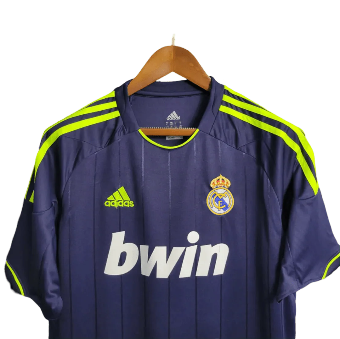 https://cdn.shopify.com/s/files/1/0826/7228/8075/files/20122013-real-madrid-bwin-away-retro-kit-377074.webp?v=1741197478