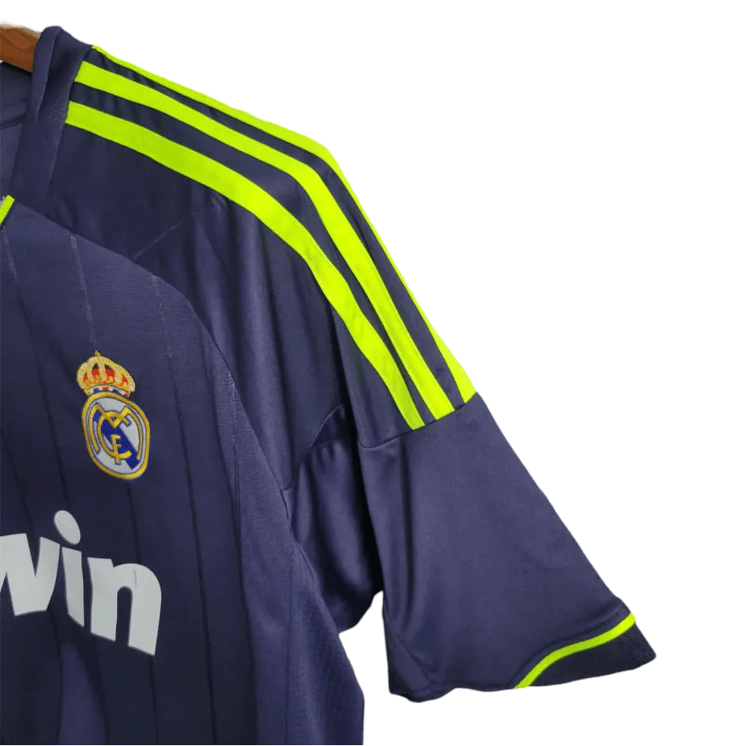 https://cdn.shopify.com/s/files/1/0826/7228/8075/files/20122013-real-madrid-bwin-away-retro-kit-524974.webp?v=1741197478