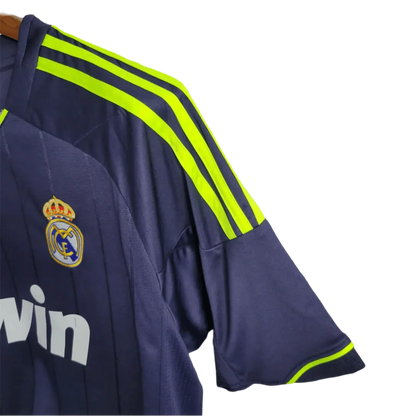 https://cdn.shopify.com/s/files/1/0826/7228/8075/files/20122013-real-madrid-bwin-away-retro-kit-524974.webp?v=1741197478