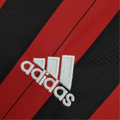 https://cdn.shopify.com/s/files/1/0826/7228/8075/files/20132014-ac-milan-fly-emirates-home-retro-kit-228318.webp?v=1741197453