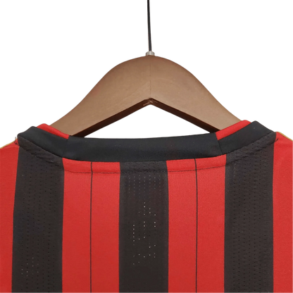 https://cdn.shopify.com/s/files/1/0826/7228/8075/files/20132014-ac-milan-fly-emirates-home-retro-kit-344877.webp?v=1741197451