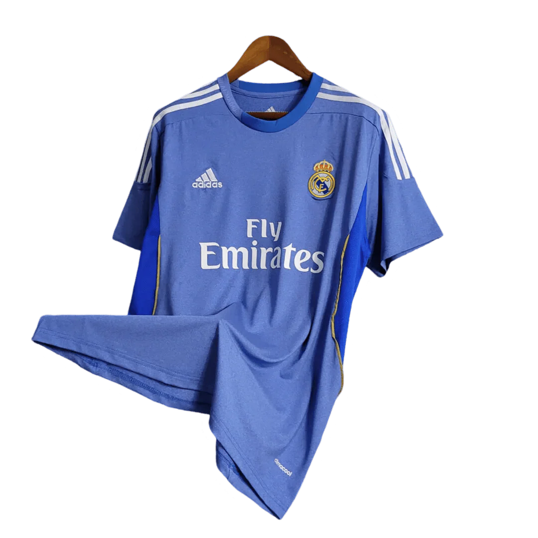 https://cdn.shopify.com/s/files/1/0826/7228/8075/files/20132014-real-madrid-fly-emirates-away-retro-kit-350912.webp?v=1741197457