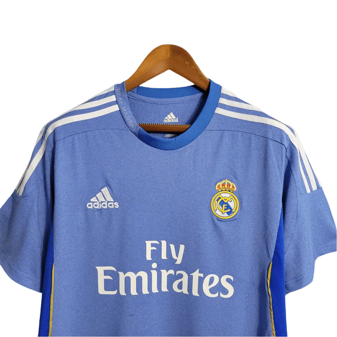 https://cdn.shopify.com/s/files/1/0826/7228/8075/files/20132014-real-madrid-fly-emirates-away-retro-kit-528540.webp?v=1741197460