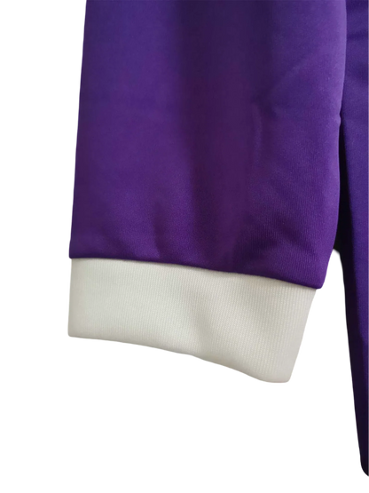https://cdn.shopify.com/s/files/1/0826/7228/8075/files/20162017-real-madrid-fly-emirates-away-purple-retro-kit-long-sleeves-515200.webp?v=1741197487