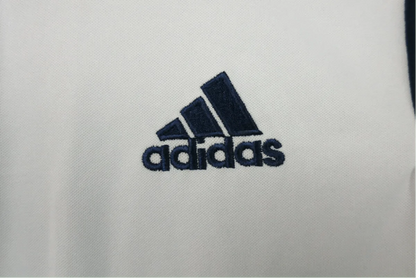 https://cdn.shopify.com/s/files/1/0826/7228/8075/files/20162017-real-madrid-fly-emirates-home-retro-kit-148447.webp?v=1741197451