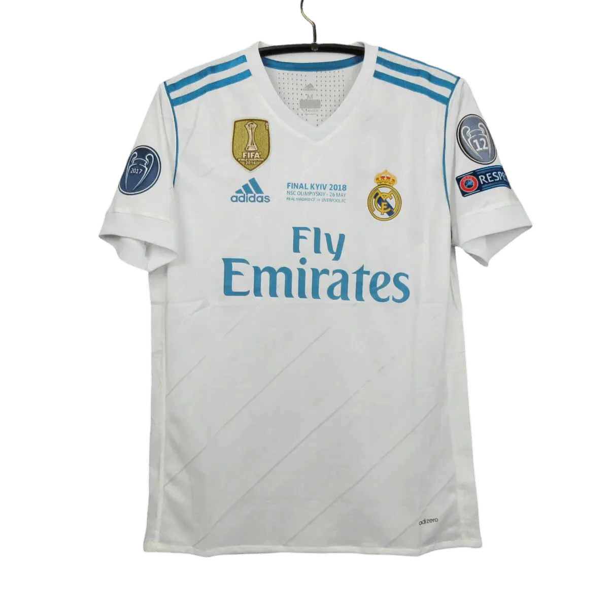 https://cdn.shopify.com/s/files/1/0826/7228/8075/files/20172018-real-madrid-fly-emirates-home-retro-kit-714980.webp?v=1741197467