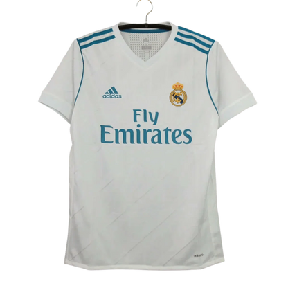https://cdn.shopify.com/s/files/1/0826/7228/8075/files/20172018-real-madrid-fly-emirates-home-retro-kit-740369.webp?v=1741197468