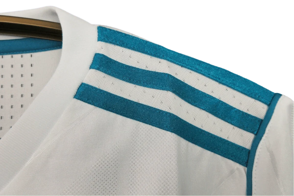 https://cdn.shopify.com/s/files/1/0826/7228/8075/files/20172018-real-madrid-fly-emirates-home-retro-kit-751053.webp?v=1741197468