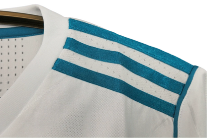 https://cdn.shopify.com/s/files/1/0826/7228/8075/files/20172018-real-madrid-fly-emirates-home-retro-kit-751053.webp?v=1741197468