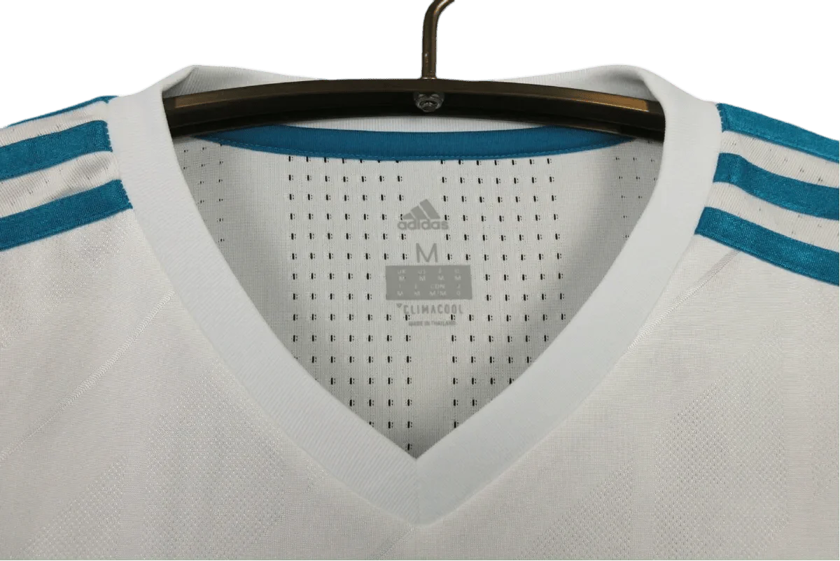 https://cdn.shopify.com/s/files/1/0826/7228/8075/files/20172018-real-madrid-fly-emirates-home-retro-kit-865007.webp?v=1741197470