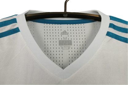 https://cdn.shopify.com/s/files/1/0826/7228/8075/files/20172018-real-madrid-fly-emirates-home-retro-kit-865007.webp?v=1741197470
