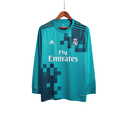 https://cdn.shopify.com/s/files/1/0826/7228/8075/files/20172018-real-madrid-fly-emirates-third-away-retro-kit-long-sleeves-276062.webp?v=1741197436