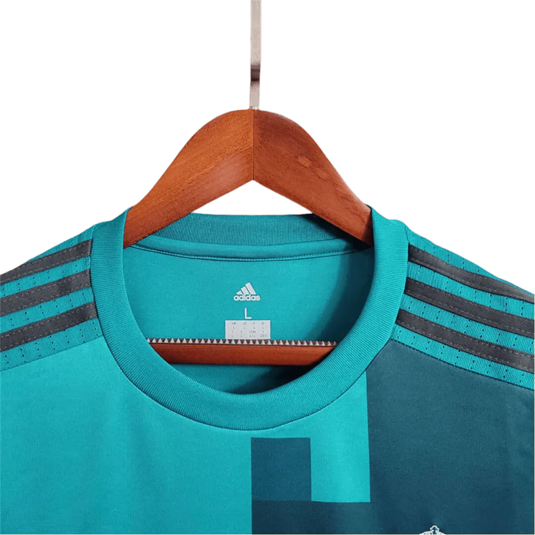 https://cdn.shopify.com/s/files/1/0826/7228/8075/files/20172018-real-madrid-fly-emirates-third-away-retro-kit-long-sleeves-888813.webp?v=1741197437