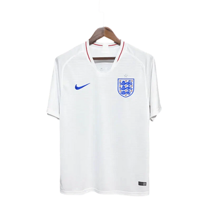 https://cdn.shopify.com/s/files/1/0826/7228/8075/files/2018-england-home-retro-kit-190368.webp?v=1741196963