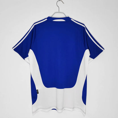 https://cdn.shopify.com/s/files/1/0891/1768/8155/files/GreeceHomeShirt2004-back.jpg?v=1741964977