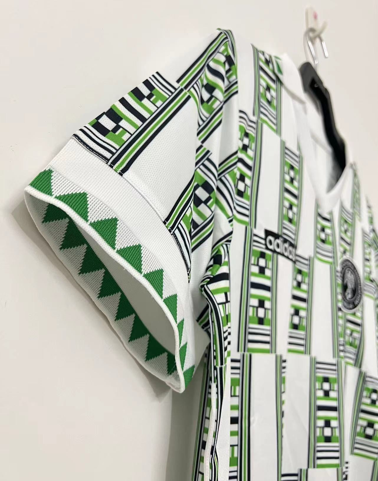 https://cdn.shopify.com/s/files/1/0891/1768/8155/files/Nigeriaawayshirt1994-detail.jpg?v=1740564272